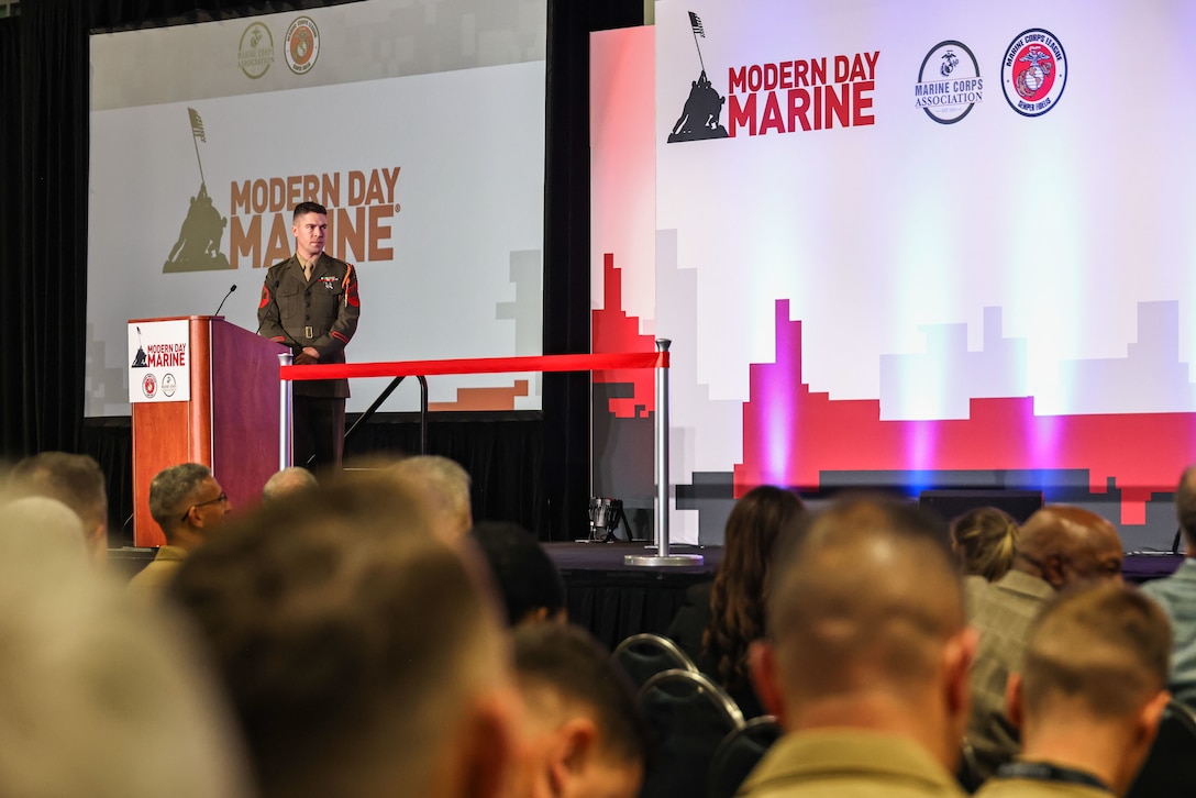 U.S. Marine Corps Sgt. Alex Liddell, narrator for "The Commandant's Own" United States Marine Drum & Bugle Corps, prepares to address attendees during the opening ceremony of Modern Day Marine 2025 in Washington, D.C., April 29, 2025. Modern Day Marine is the largest military equipment, systems, services and technology exposition open exclusively to Marines, DoD, association partners, and authorized industry representatives. Marines with Marine Barracks Washington helped by participating in various aspects during the opening ceremony of this event. (U.S. Marine Corps photo by Lance Cpl. Christopher Prelle)