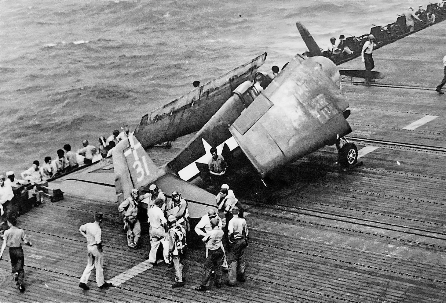 By mid-1944, the Grumman F6F Hellcat was well established as the Navy’s primary carrier fighter, replacing the F4F Wildcat that had served so well in the first two years of the Pacific war. Here, deck crewmen make post-recovery checks on a Hellcat from Fighting Squadron (VF) 18 aboard USS Intrepid (CV 11) after the fighter flew a mission against Japanese airfields around Clark Airfield in the Philippines on Oct. 29. VF-18 claimed 35 kills over enemy aircraft. Leading ace Lt. Cecil Harris (23 kills total count) claimed four kills (all fighters) that day.