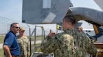 Cmdr. Joseph Stewart, right, a Reservist on the Naval Air Systems Command (NAVAIR) Forward Deployed Combat Repair (FDCR) Team, discusses the results of the FDCR training exercise with Fleet Readiness Center East (FRCE) Commanding Officer Capt. Randy Berti, middle, and Executive Director David Rose, left. FRCE hosted seven NAVAIR Reservists May 12-16 to train alongside the depot’s FDCR Teams in a scenario that included making hands-on repairs to stricken MV-22 Osprey and CH-53E Super Stallion aircraft with simulated battle damage.