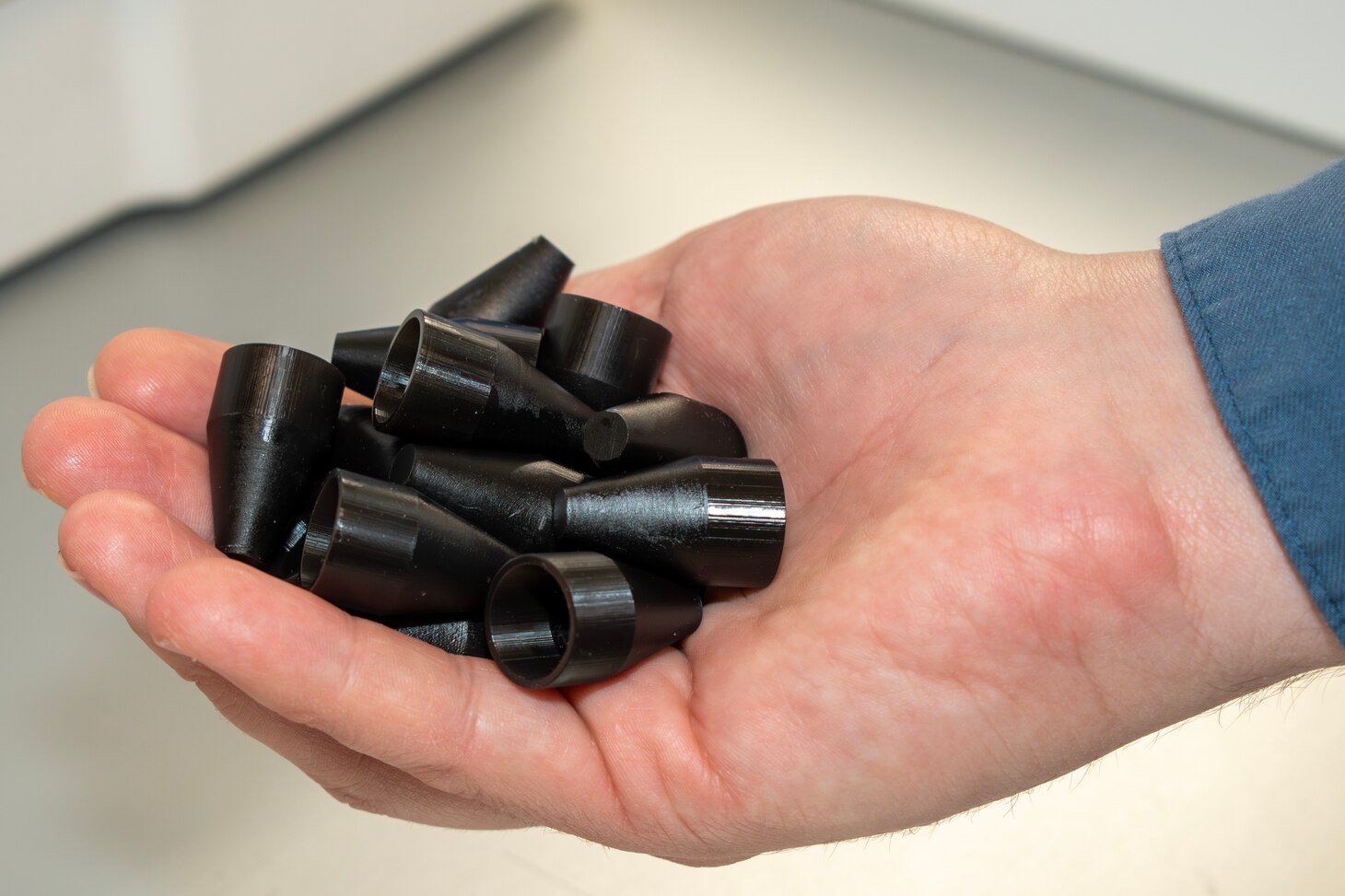 Fleet Readiness Center East Innovation Lab Lead Engineer Jeremy Bunting displays a handful of an F-35 O-ring installation tool recently manufactured by the lab. The two-person team at the Innovation Lab used additive manufacturing–commonly referred to as 3D printing–to fulfill a critical request for 2,000 tools, and successfully completed the order under two weeks. Within days, the effort put tools in aircraft maintainers’ hands across the U.S. Marine Corps, Navy and Air Force. The turnaround time represented less than 10% of the estimated six months procurement would have taken through traditional acquisition methods.