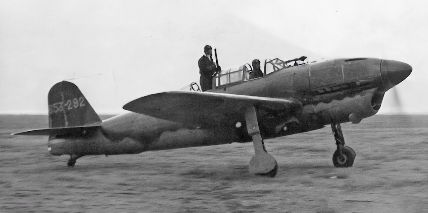 The Yokosuka D4Y Suisei (Comet) was one of the best dive bombers in service in the Pacific, and it came in two versions, D4Y3, which used a radial engine, and the D4Y1 and the D4Y2, which used a liquid-cooled engine. In this photo of a taxiing D4Y2, the observer stands to help his pilot clear any potential obstacles.