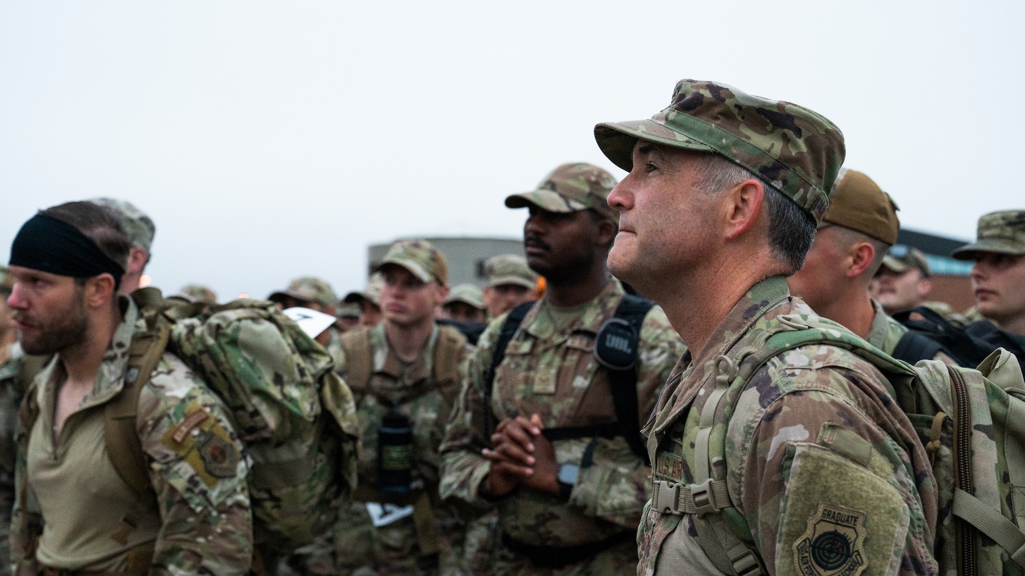 U.S. Air Force Col. Jesse Lamarand, 5th Bomb Wing commander (right), listens to a safety briefing alongside other Airmen.