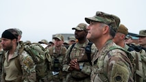 U.S. Air Force Col. Jesse Lamarand, 5th Bomb Wing commander (right), listens to a safety briefing alongside other Airmen.