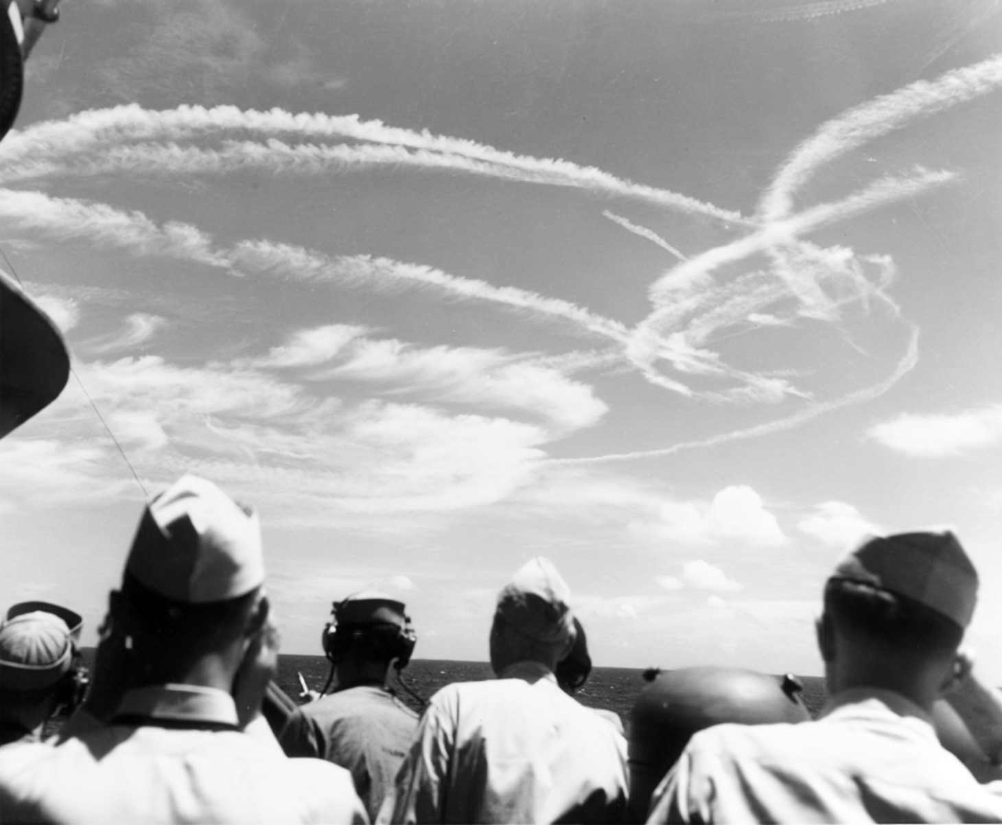In this well-known photo, observers aboard the cruiser USS Birmingham (CL 62) watch the many contrails over Task Force 58 during the Battle of the Philippine Sea June 19, 1944. The historic aerial engagement became known as the Marianas Turkey Shoot, the results of which were staggering. Out of the 373 aircraft the Japanese launched, 243 were lost in the swirling dogfights above the task force. Of the 296 Hellcats engaged, only 14 were lost in the many combats, with six more lost for operational reasons.