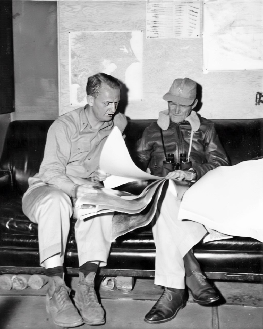 Two of the eventually best known and most highly capable American senior fleet commanders, Vice Adm. (later admiral) Marc A. Mitscher and Commodore (a war-time one-star rank) Arleigh A. Burke (later admiral) converse aboard USS Bunker Hill (CV 17) in February 1945. Burke was Mitscher’s chief of staff and the two men enjoyed a good relationship throughout the war. Mitscher is wearing his familiar ball cap and occasional flight jacket.