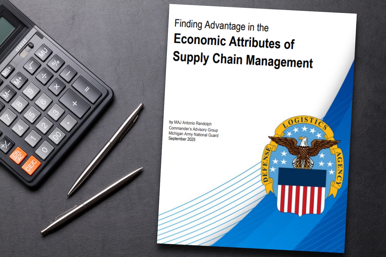 The cover of the white paper appears on a desktop next to a calculator and pens