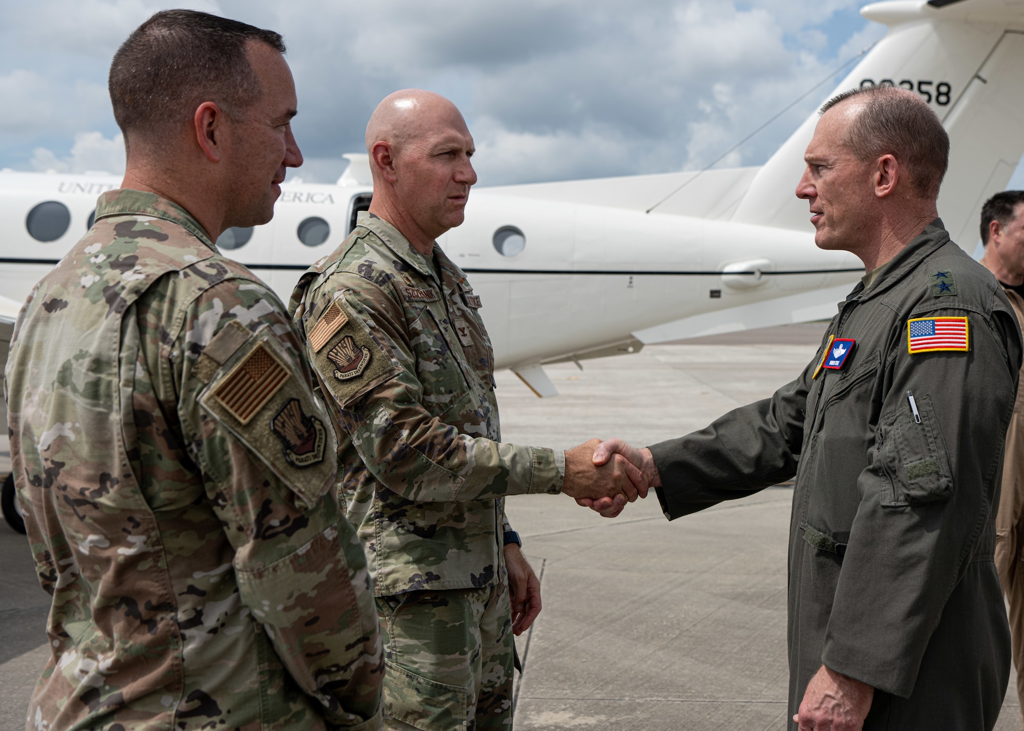U.S. Air Force Col. Edward Szczepanik, 6th Air Refueling Wing commander, greets Maj. Gen. Darren Cole, 21st Air Force and U.S. Air Force Expeditionary Center commander, before his departure from MacDill Air Force Base, Florida, Sept. 17, 2025. The strategic realignment of Air Mobility Command units under the 21st Air Force diversifies mission sets and better equips Airmen to project and sustain power in support of national strategic objectives. (U.S. Air Force photo by Airman 1st Class Helen Ly)