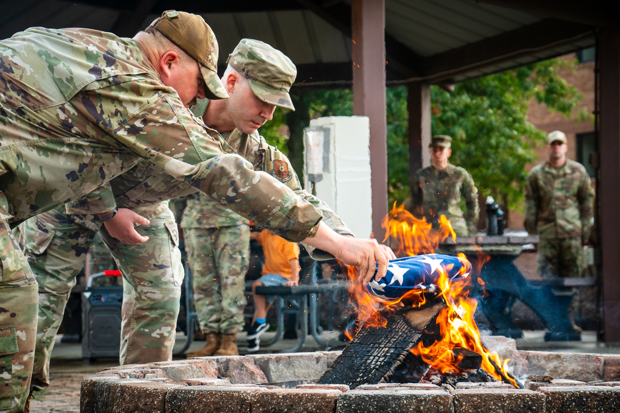 Master sergeant selects retire an unserviceable flag during the Senior Noncommissioned Officer Induction Course at Whiteman Air Force Base, Missouri, Sept. 17, 2025. The student-led ceremony honored the flag with dignity and respect while reinforcing traditions and responsibilities of the senior NCO corps. (U.S. Air Force photo by Senior Airman Robert Hicks)