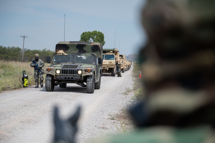 An Airman from Altus Air Force Base’s 97th Civil Engineer Squadron, Readiness and Emergency Management Flight simulates decontaminating a U.S. Army vehicle during an exercise at Fort Sill, Oklahoma, September 7, 2025. During the exercise, Soldiers from the 3-2 Air Defense Artillery Battalion simulated exposure to an unknown Chemical, Biological, Radiological, and Nuclear agent. This forced them to rapidly break down their camp and move all personnel and equipment through a decontamination line before establishing a new position. (U.S. Air Force photo by Tech. Sgt. Hailey Haux)