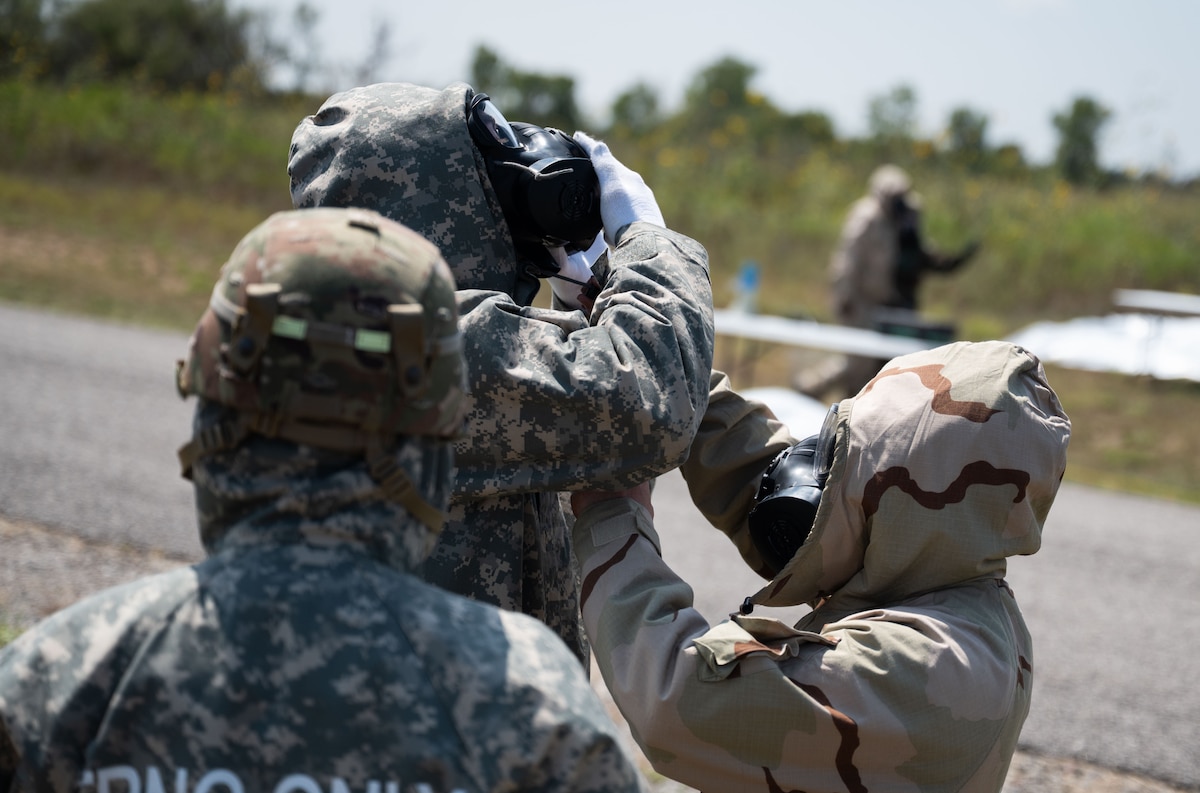 U.S. Army Soldiers with the 3-2 Air Defense Artillery Battalion are instructed on how to take off their chemical gear during a decontamination exercise at Fort Sill, Oklahoma, September 7, 2025. Airmen from Altus Air Force Base’s 97th Civil Engineer Squadron, Readiness and Emergency Management Flight traveled to Fort Sill, Oklahoma, to support the U.S. Army’s 3-2 Air Defense Artillery Battalion in achieving its Chemical, Biological, Radiological, and Nuclear training objectives. (U.S. Air Force photo by Tech. Sgt. Hailey Haux)