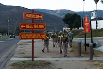 U.S. Marines with Fire Support Battalion, 11th Marine Regiment, 1st Marine Division, hike to their next station during the company fire support team competition at Marine Corps Base Camp Pendleton, California, Sept. 19, 2025. The company FST competition tests teams’ technical and tactical skills under stress, building proficiency, teamwork, and readiness to integrate fires effectively in combat. (U.S. Marine Corps photo by Sgt. Atticus Martinez)