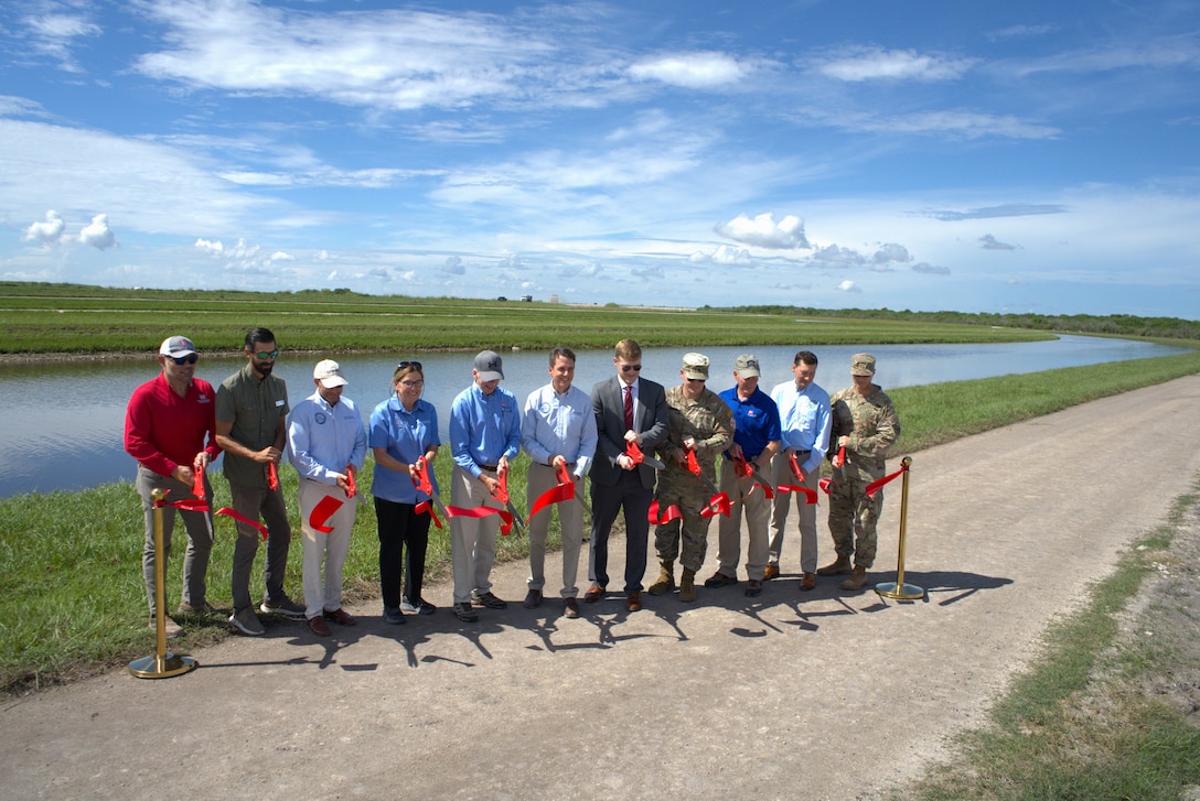 Leaders from the U.S. Army Corps of Engineers Jacksonville District, the Florida Department of Environmental Protection, and the South Florida Water Management District cut the ribbon Sept. 23, 2025, in South Bay, Fla., to celebrate completion of Contract 10A of the Everglades Agricultural Area (EAA) Reservoir Project. The 8.3-mile canal and maintenance road are essential components of the Central Everglades Planning Project (CEPP), designed to store, clean, and move water south to improve water quality and restore America’s Everglades. Photo by: Misty Cunningham