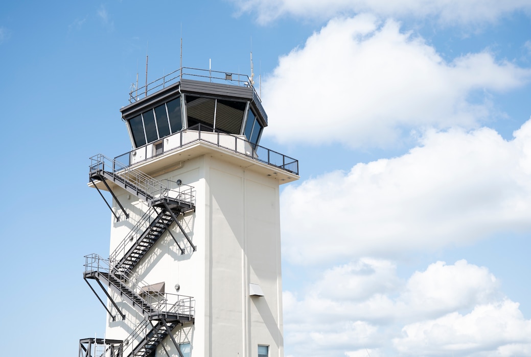A tall white tower stands against the sky.