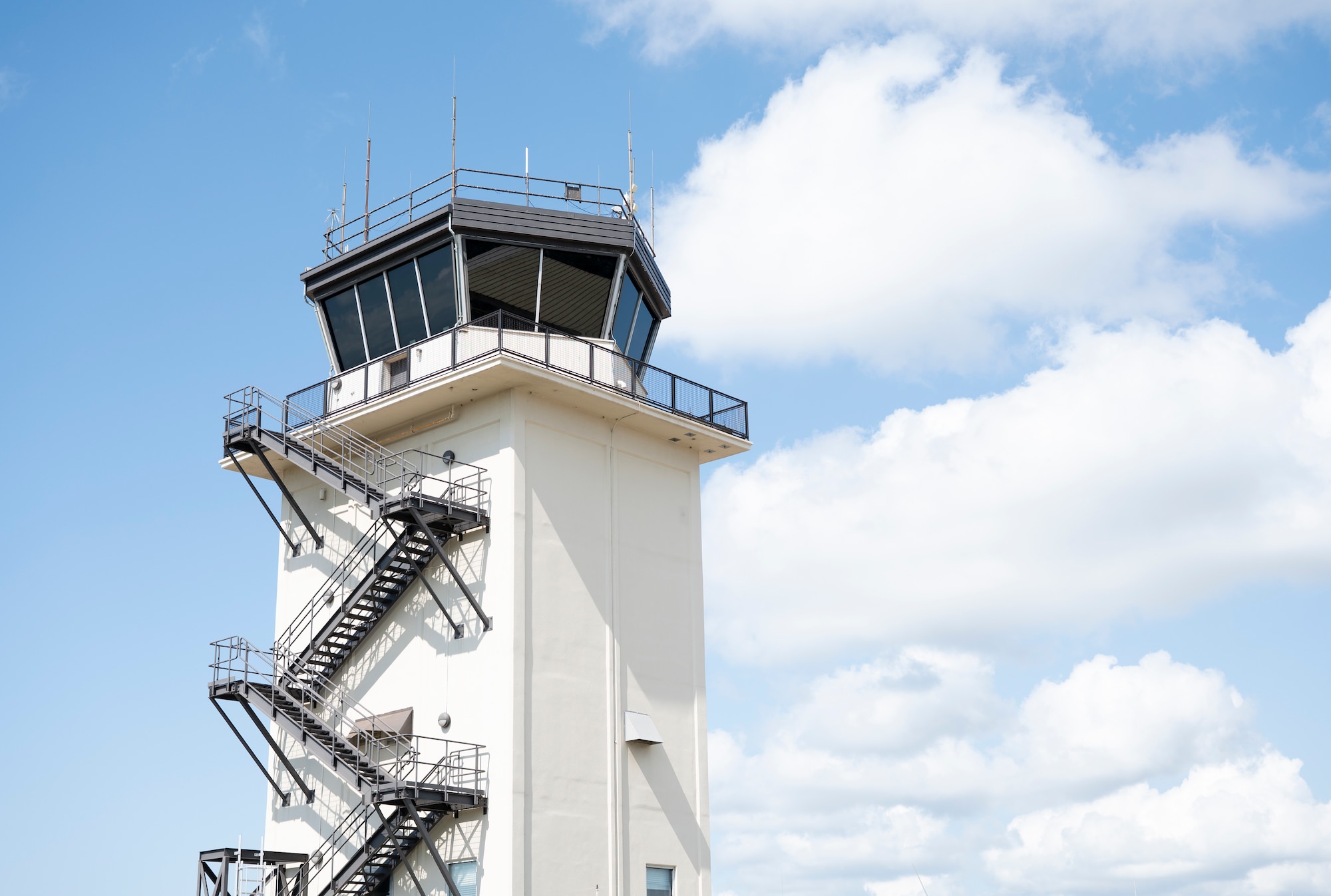A tall white tower stands against the sky.