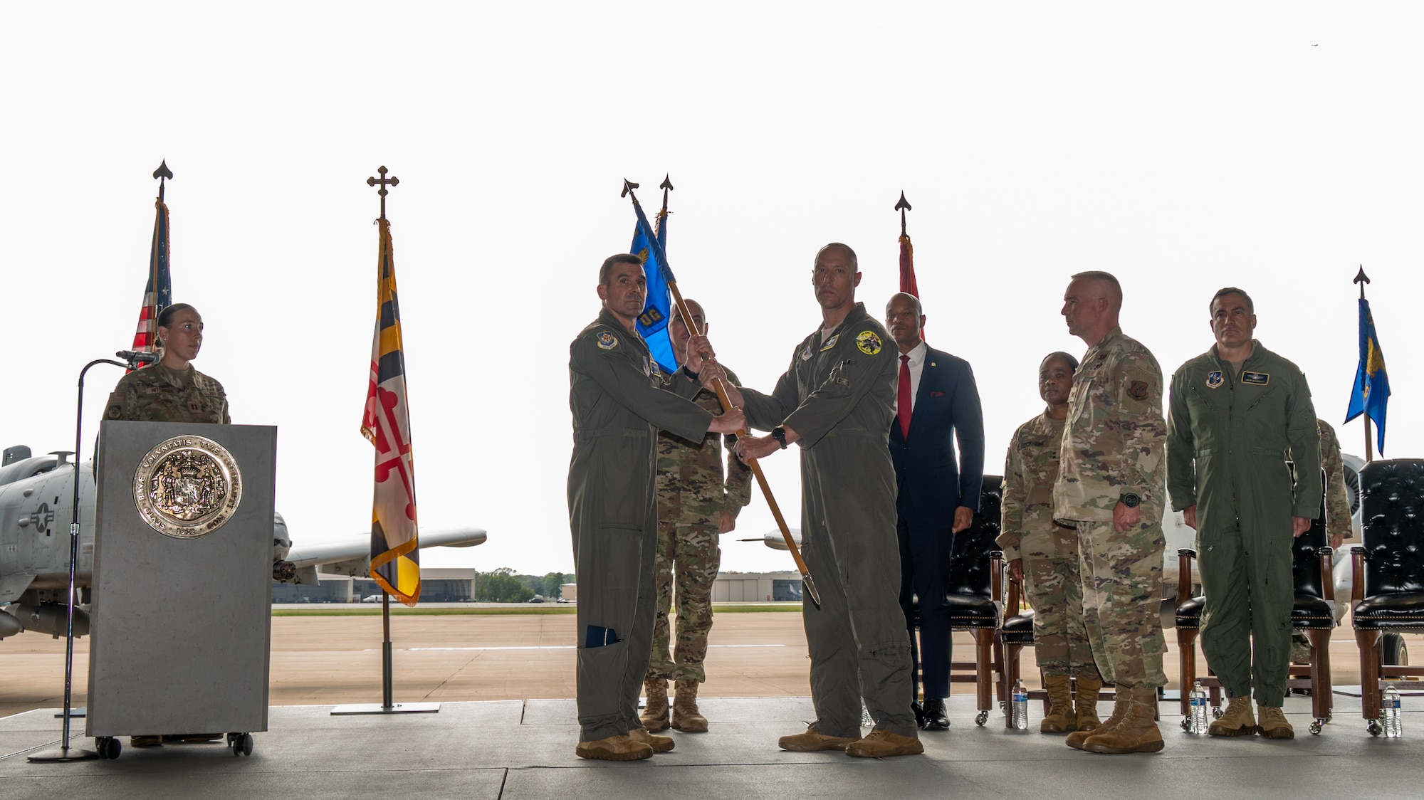 Maryland Air National Guard Col. Christopher Palmer (right), commander of the 175th Operations Group, passes the guidon to Maryland Air National Guard Brig. Gen. Richard Hunt (left), commander of the 175th Wing, before the traditional furling of the unit's guidon, at Warfield Air National Guard Base at Martin State Airport, September 23, 2025.