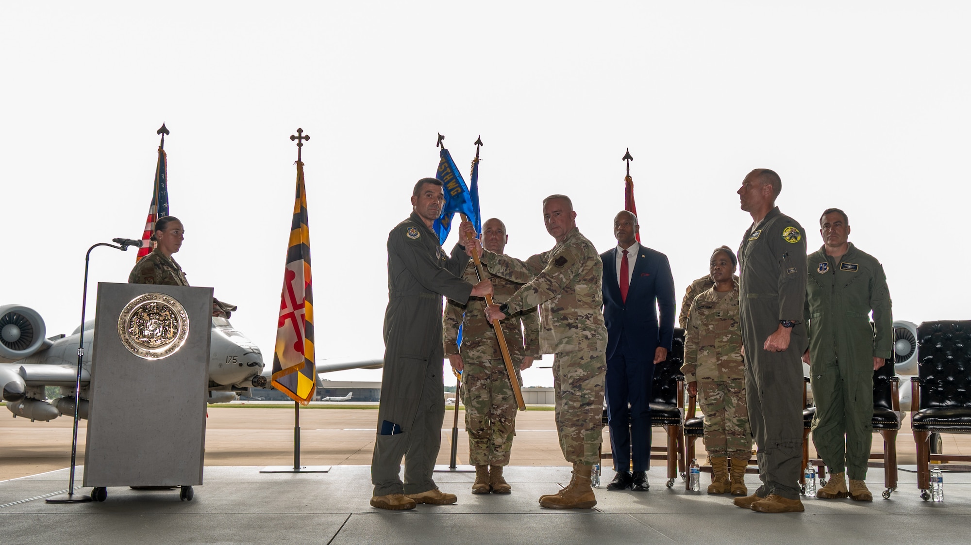 Maryland Air National Guard Col. Jason Burns (right), commander of the 175th Maintenance Group, passes the guidon to Maryland Air National Guard Brig. Gen. Richard Hunt (left), commander of the 175th Wing, before the traditional furling of the unit's guidon, at Warfield Air National Guard Base at Martin State Airport, September 23, 2025.