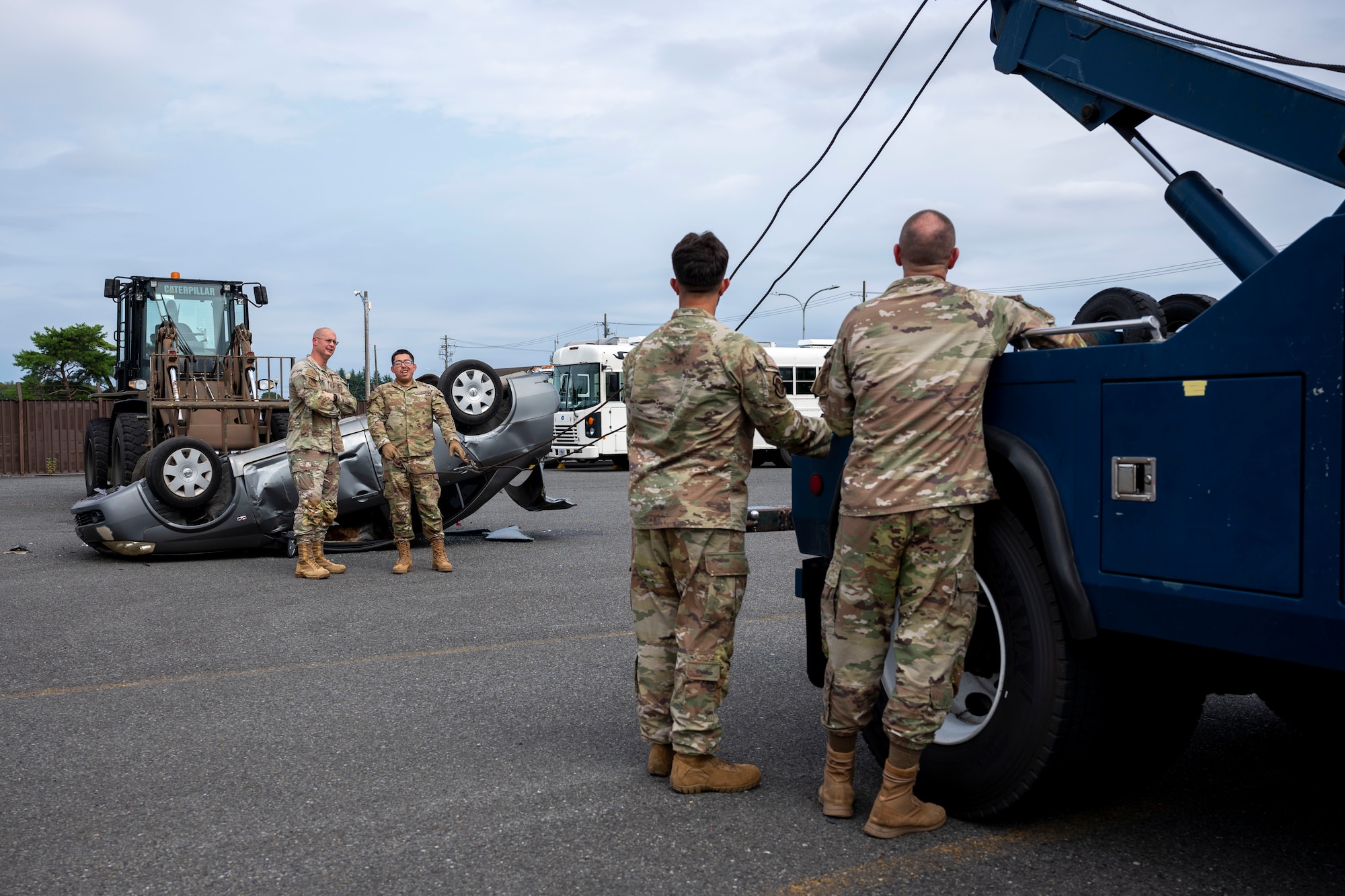 Military members speak during a vehicle rollover training.