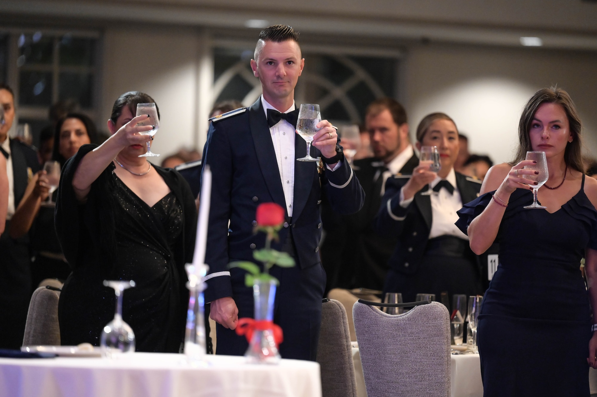 Airmen and guests give a toast during a moment of silence.