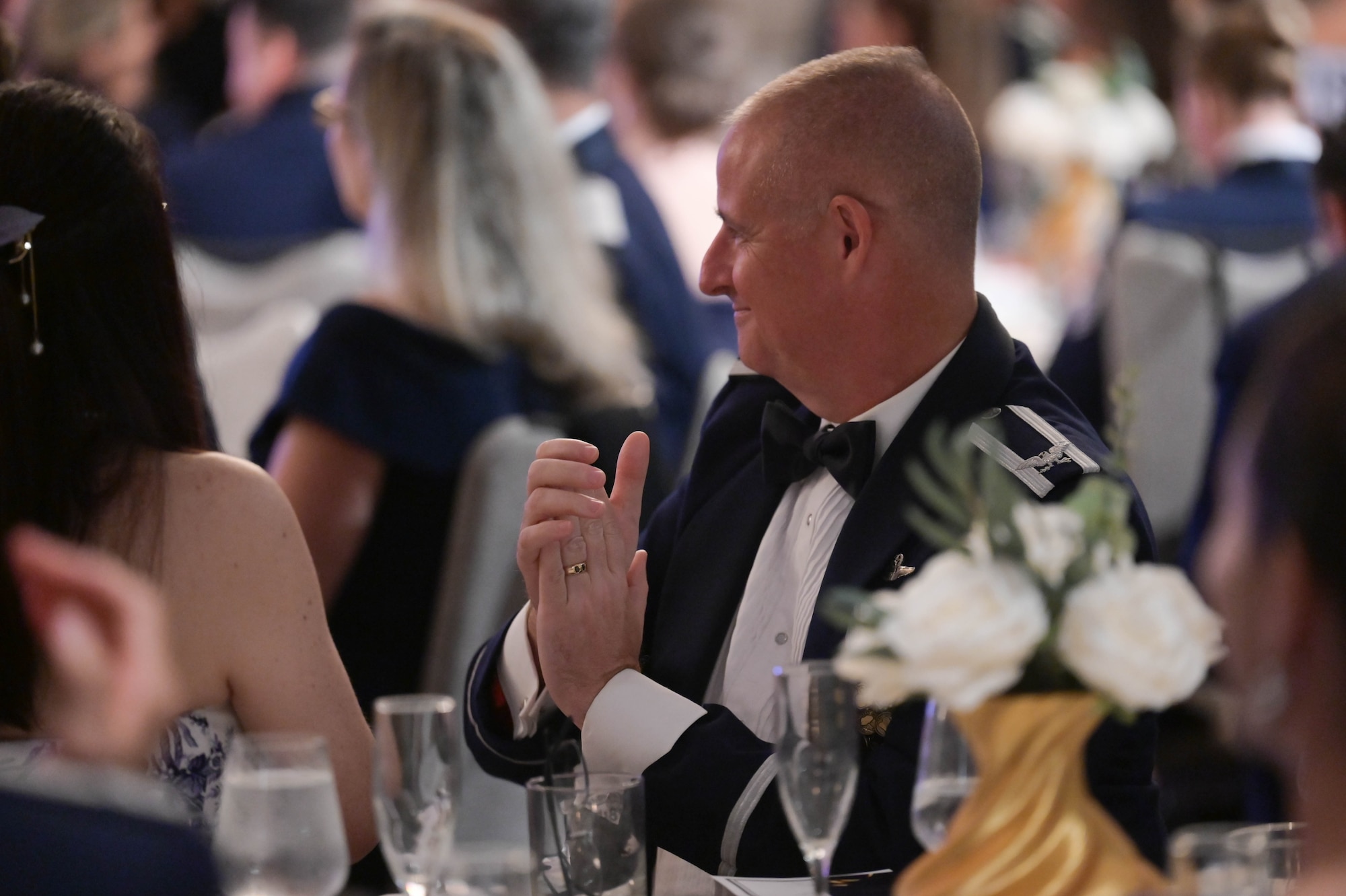 An Airman claps during a ceremony.