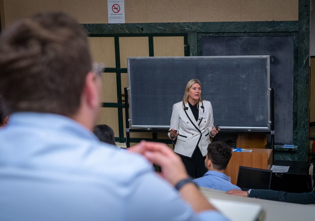 Dr. Debra Prince Zinni, Defense POW/MIA Accounting Agency laboratory director and supervisory forensic anthropologist, briefs about the collaboration and complexities that are involved in transporting human remains across international borders during the fourth Scientific Summit in Milan, Italy, Sept. 17, 2025.