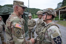Chief of Staff of the Army Gen. Randy George presents Sgt. Cesar Guiterrez, 2nd Infantry Divison, ROK-US Combined Division, with a challenge coin at Camp Casey, South Korea, Sept. 22, 2025.