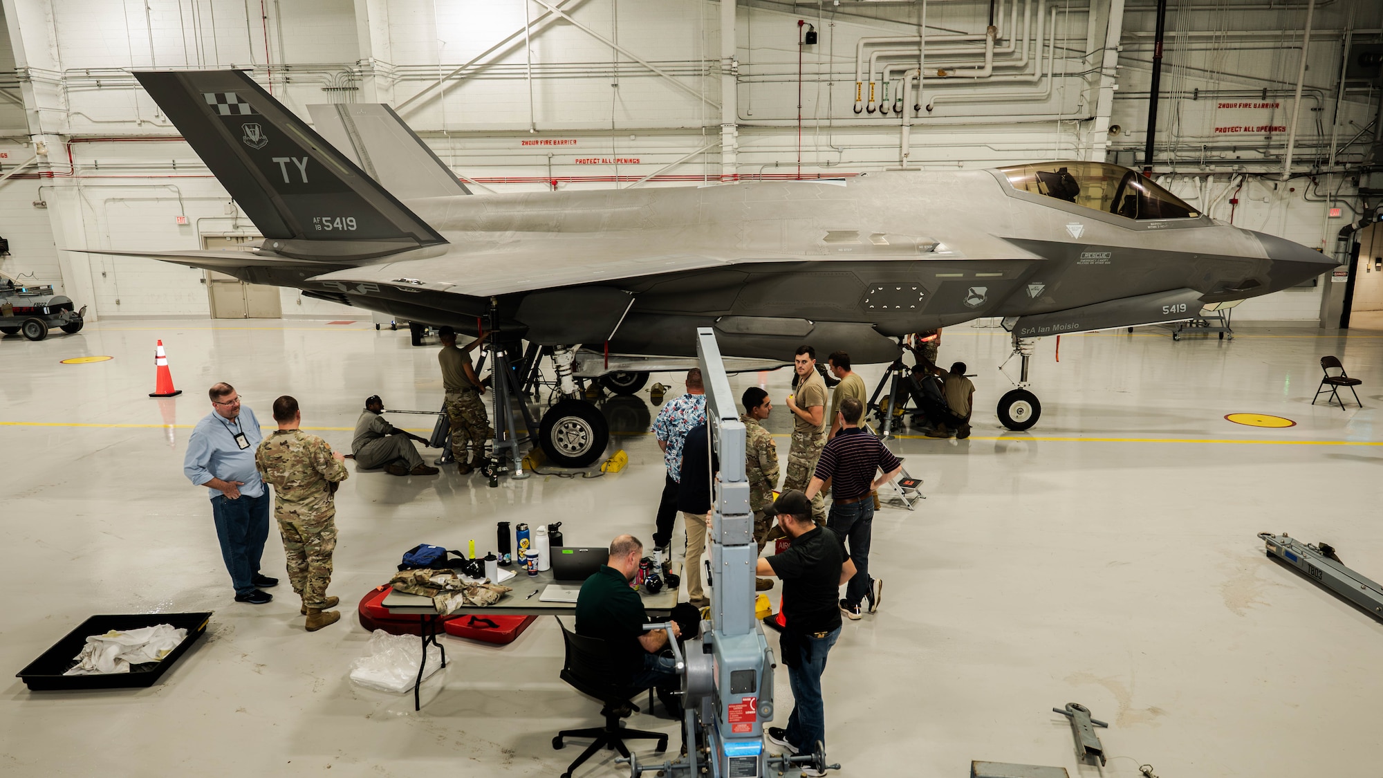 U.S. Airmen and Lockheed Martin personnel conduct load cell testing on an F-35A Lightning II