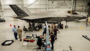 U.S. Airmen and Lockheed Martin personnel conduct load cell testing on an F-35A Lightning II
