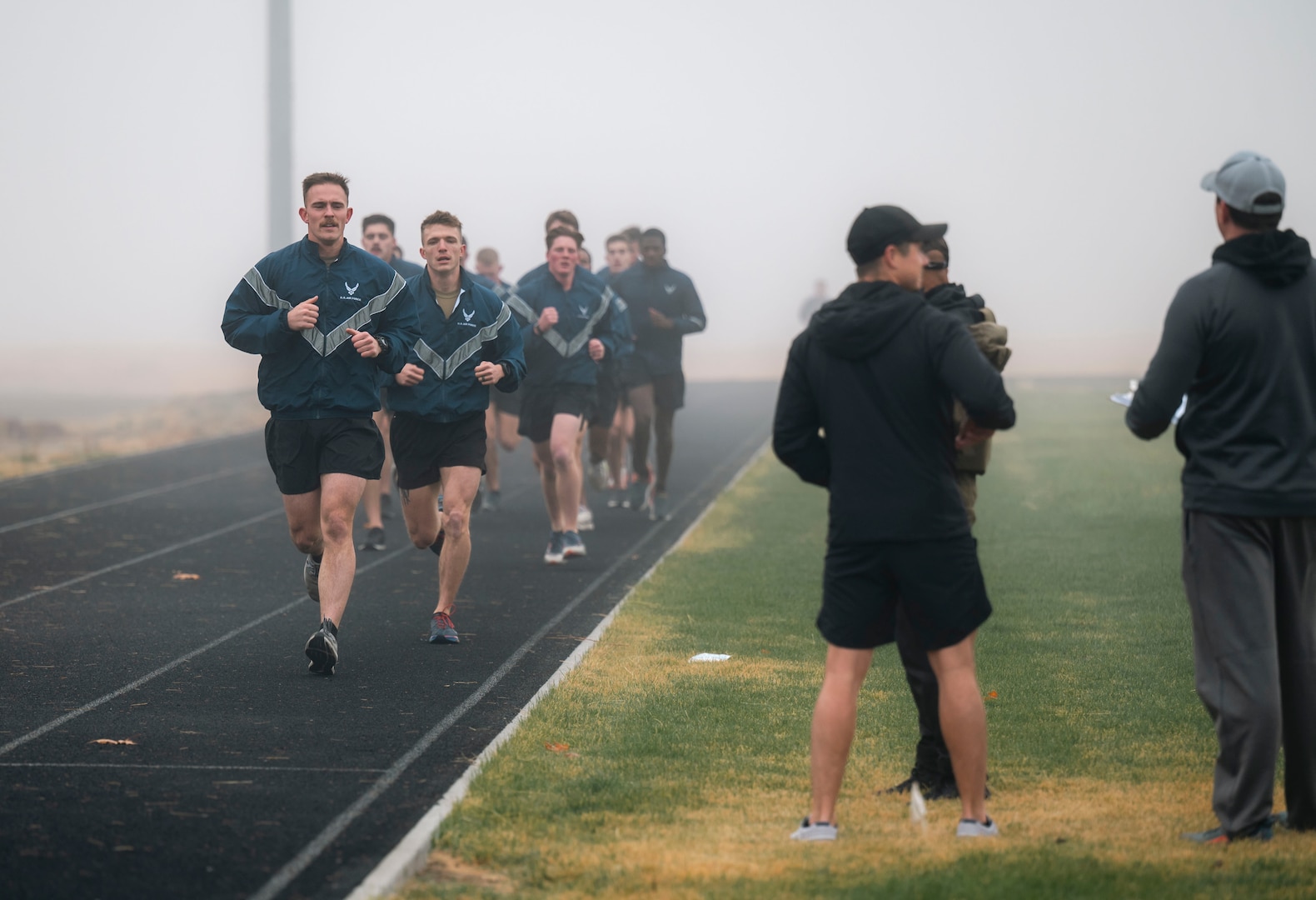 Military members perform a physical fitness test.