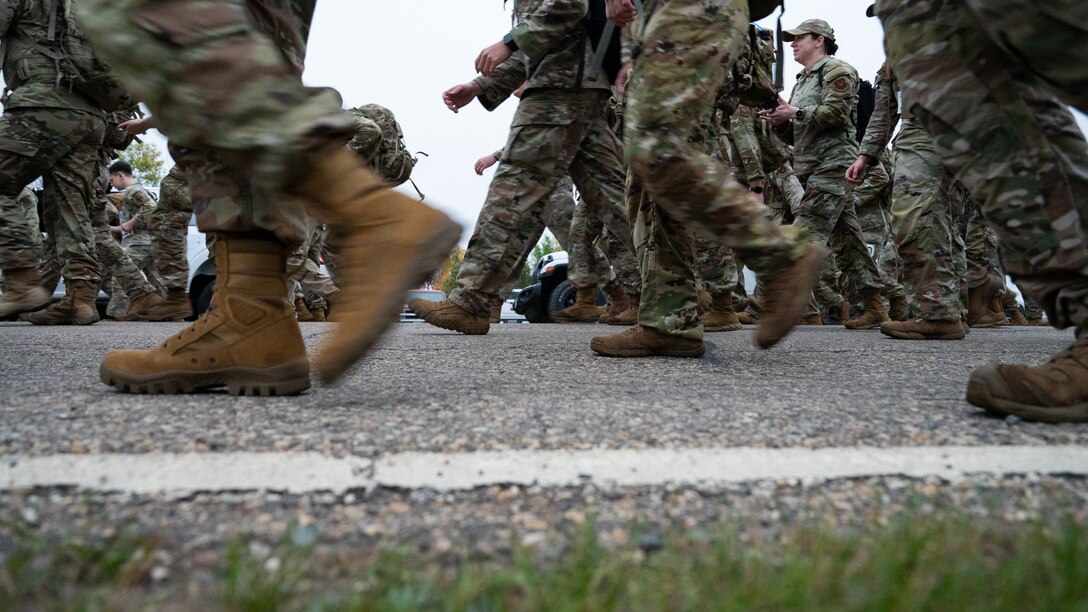 A ground-level shot of several Airmen's boots during a ruck march.