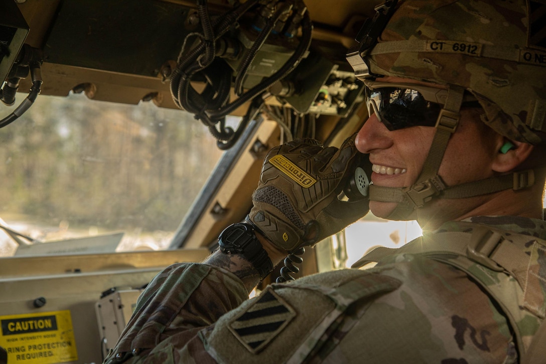 A U.S. Army soldier operates a radio system inside of a Mine-Resistant Ambush Protected All-Terrain Vehicle (MRAP).