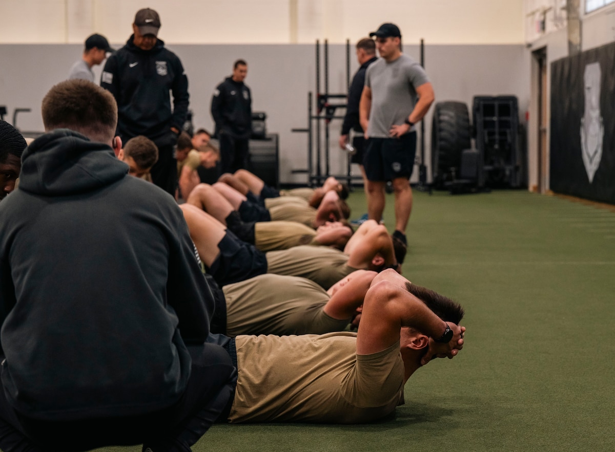 Military members perform a physical fitness assessment.