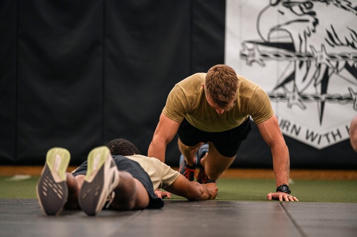 Military members perform a physical fitness assessment.