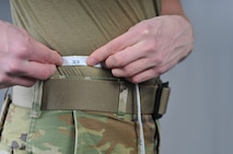 A military member performs a body composition assessment.