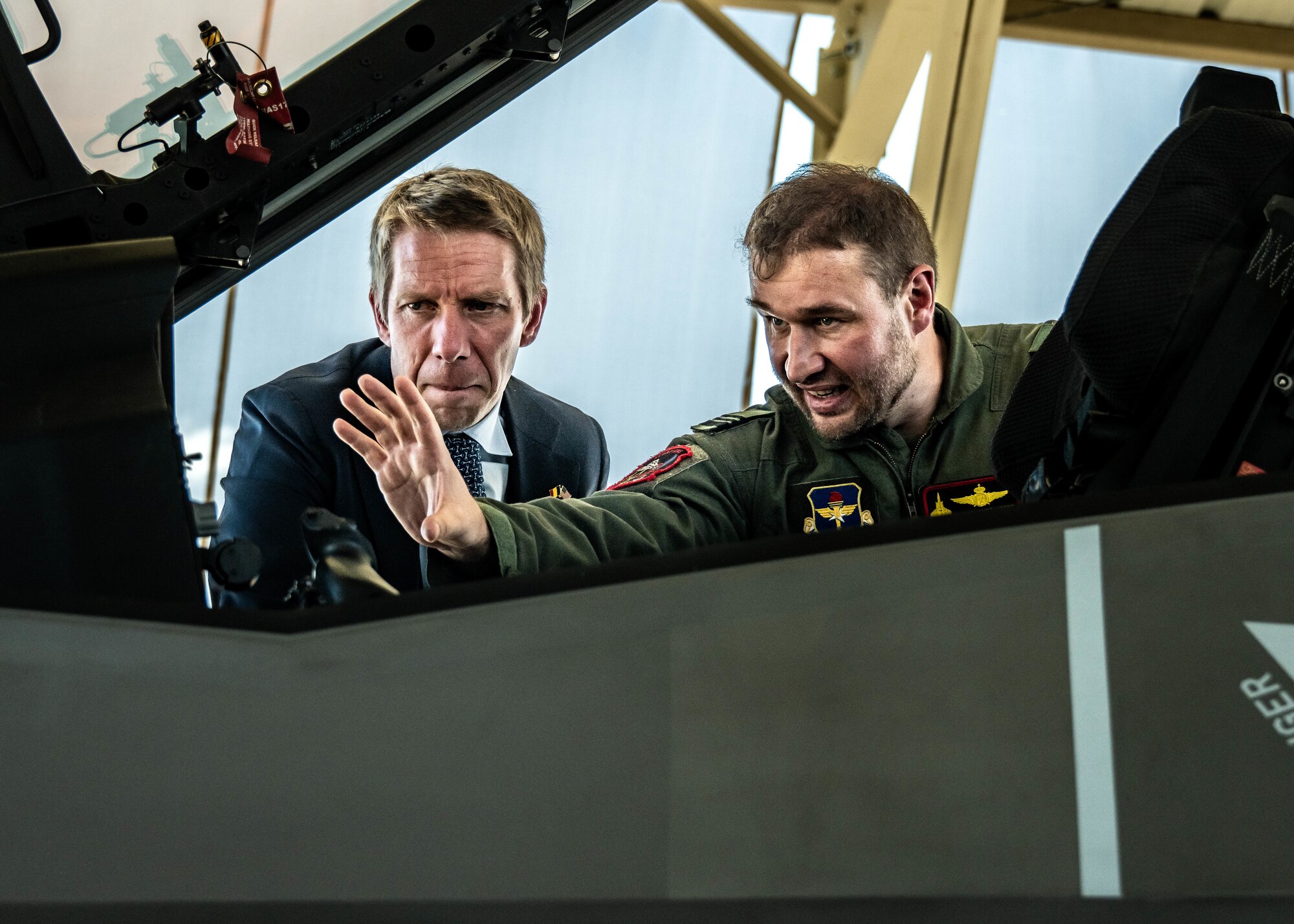 Frederic Bernard (left), Belgian Ambassador to the United States, and Belgian Air Force Lt. Col. Pierre-Yves Libert (right), 312th Fighter Squadron senior national representative, look inside the cockpit of an F-35A Lightning II