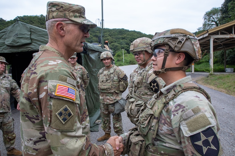 Chief of Staff of the Army Gen. Randy George presents Sgt. Cesar Guiterrez, 2nd Infantry Divison, ROK-US Combined Division, with a challenge coin at Camp Casey, South Korea, Sept. 22, 2025.