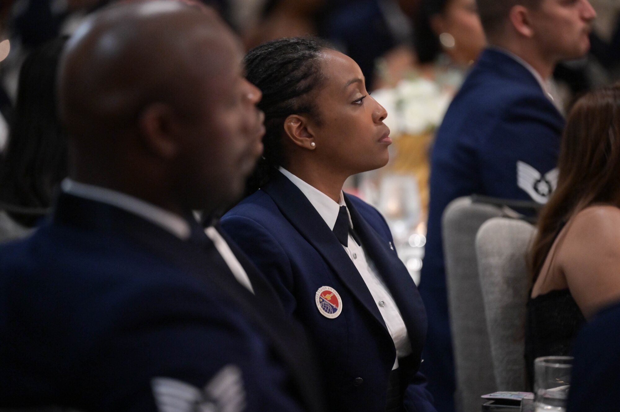 Airmen sit in attendance during a ceremony.
