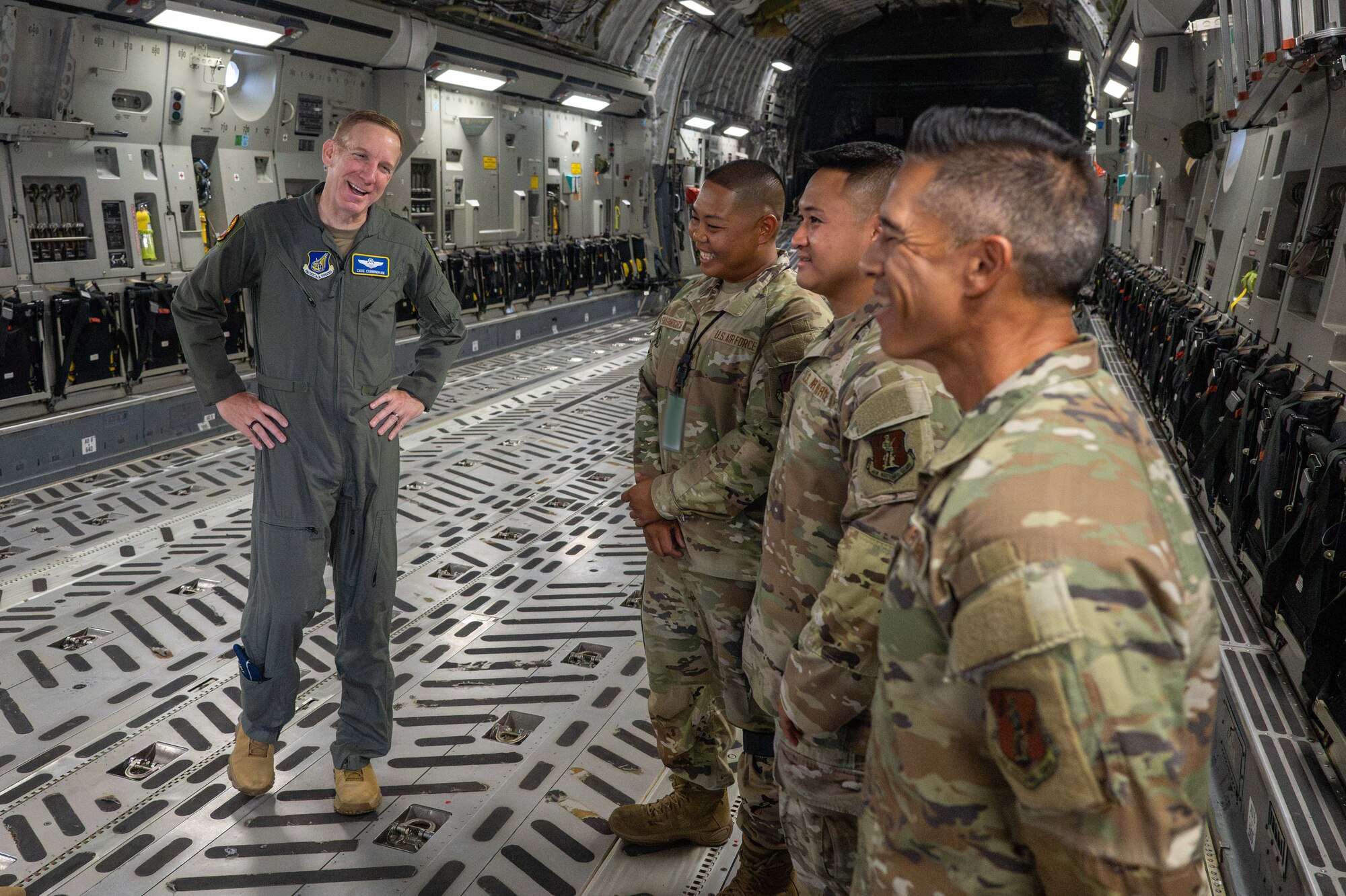 General speaks to Airmen inside of an aircraft.
