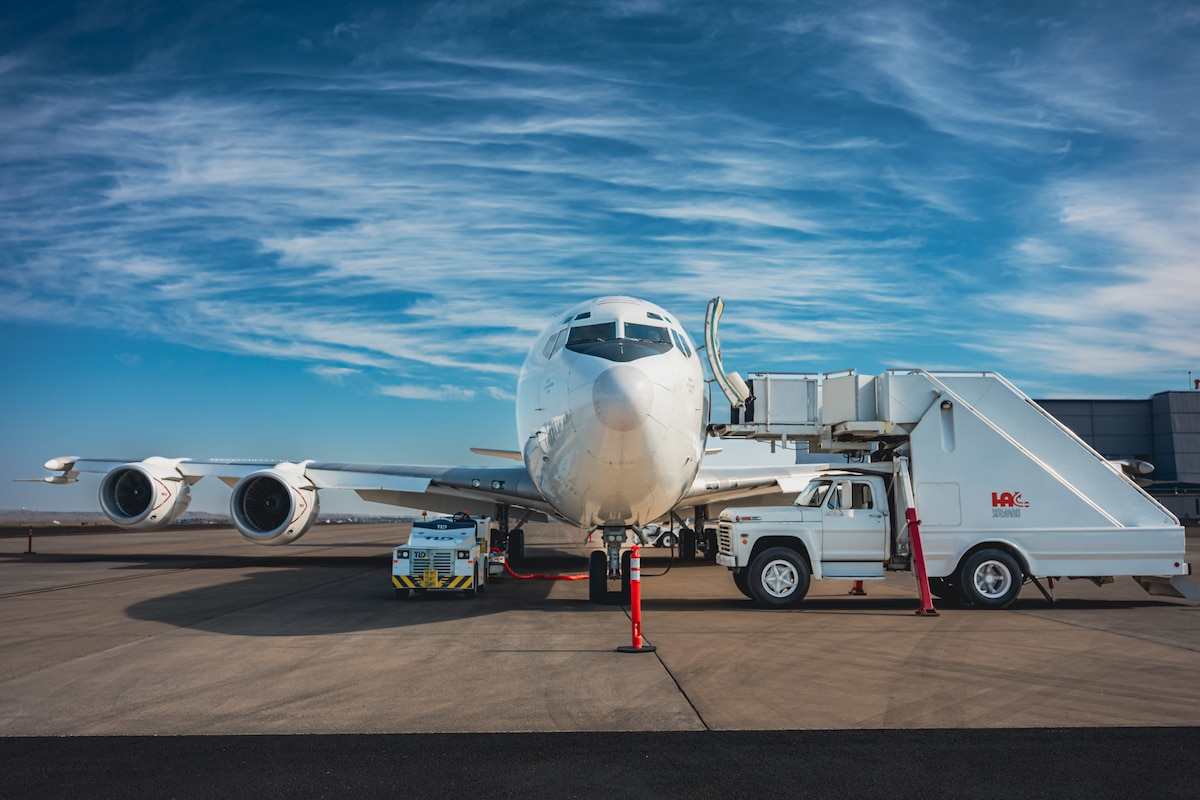 A U.S. Navy E-6B Mercury plane is parked at a tarmac.