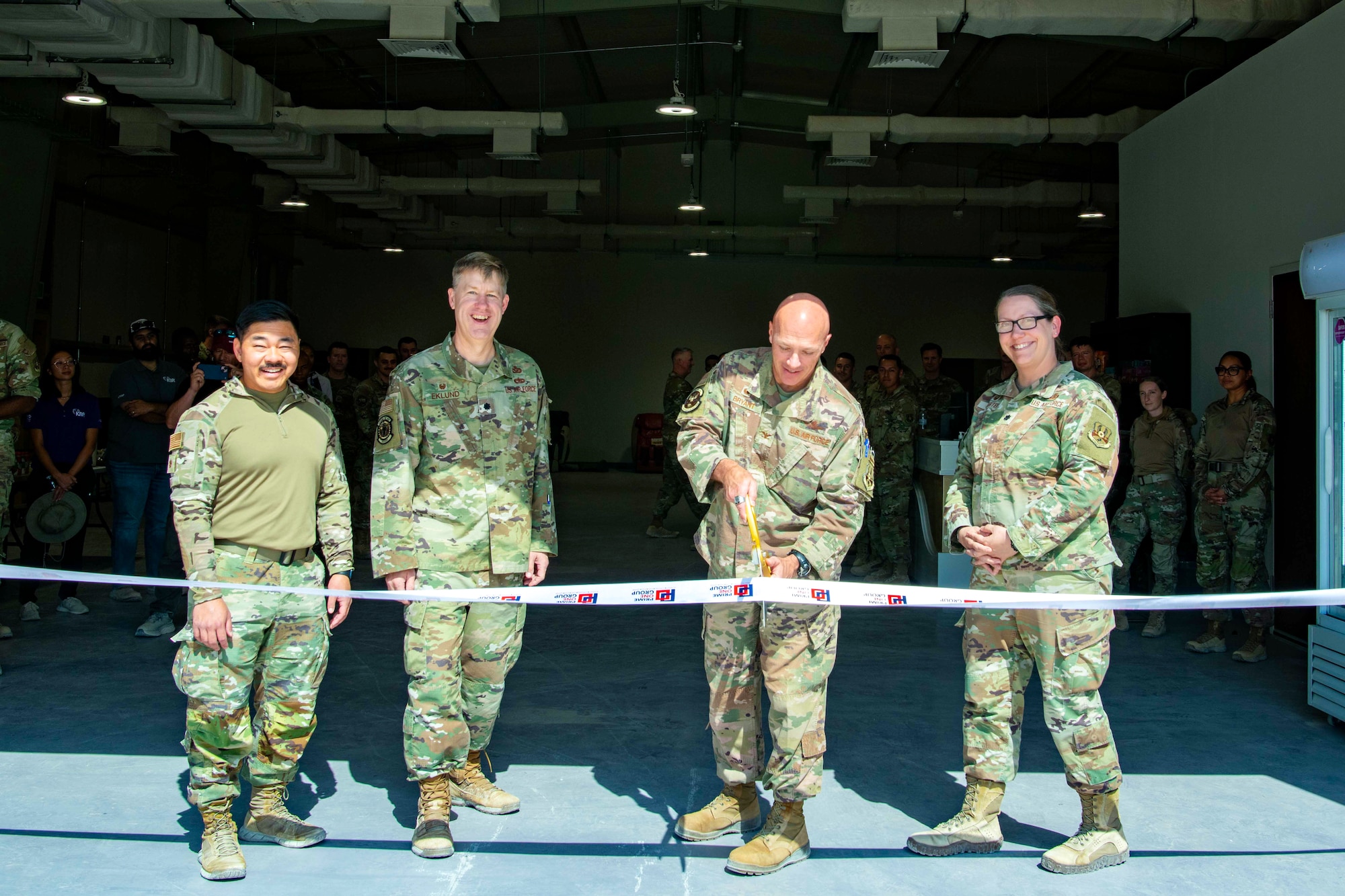 4 Airmen cut a ribbon at a newly constructed facility