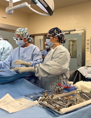 Hospital Corpsman 3rd Class Natalia Stallings and Hospital Corpsman 3rd Class Maria Lozano Mungia, assigned to Naval Medical Readiness and Training Command (NMRTC) Sigonella, assist a surgeon during a cesarean section at the naval hospital. Stallings and Lozano Mungia perform surgical counts and anticipate the surgeon’s needs with precision, demonstrating the vital role Navy surgical technologists play in ensuring patient safety and sustaining operational readiness across the fleet while honing their skills to remain ready for operational deployments.