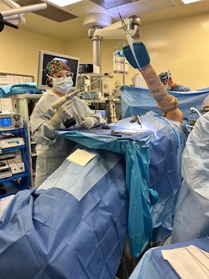 Hospital Corpsman 3rd Class Bret Burns, a surgical technologist assigned to Naval Medical Readiness and Training Command (NMRTC) Sigonella, assists a surgeon during an orthopedic procedure. Navy surgical technologists display versatility across specialties, from orthopedic to general surgery, ensuring precision and patient safety in every case while honing their skills to remain ready for operational deployments.
