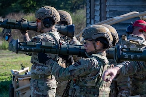 U.S. Air Force security forces Airmen aim AT4 rocket launcher simulators.