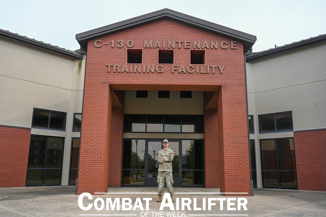 Man stands in front of a building.