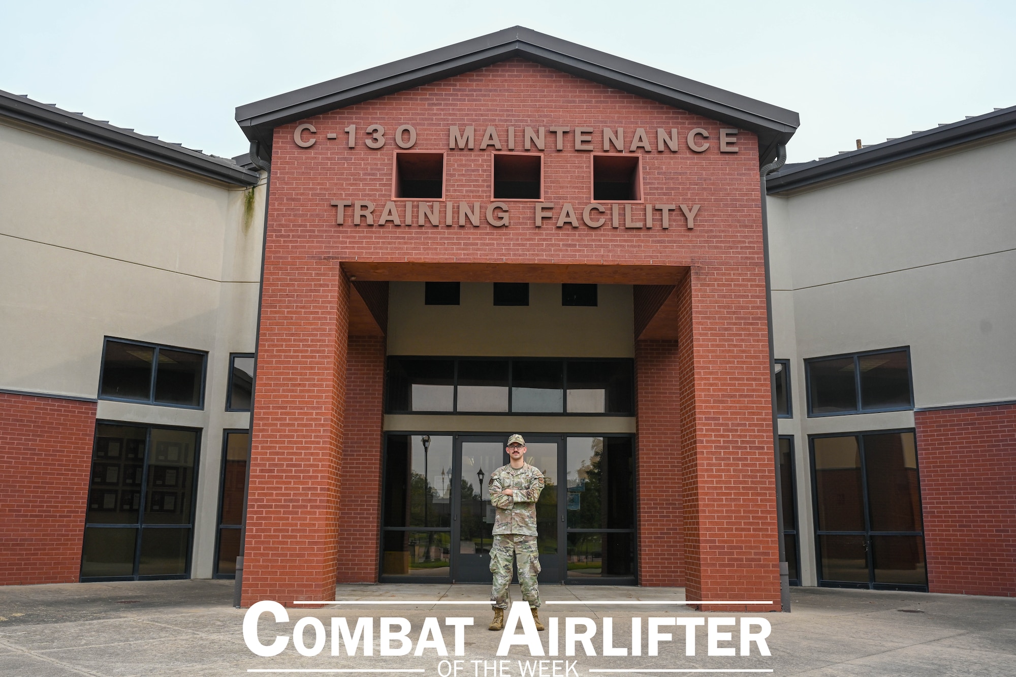 Man stands in front of a building.