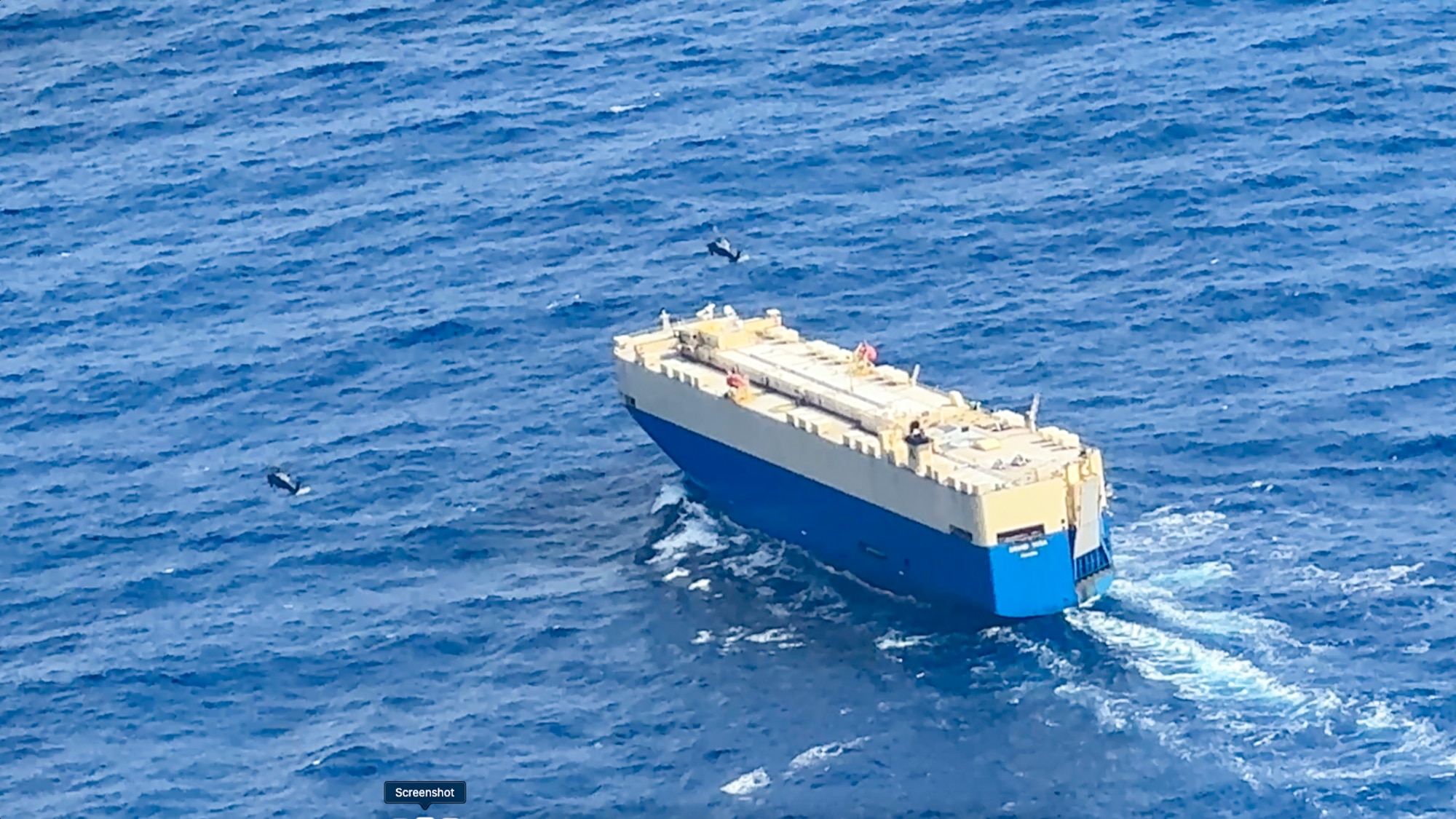 Two HH-60 helicopters from the 129th Rescue Wing, California Air National Guard, approach the Panamanian-flagged cargo vessel Grand Vega during a long-range maritime rescue mission approximately 885 nautical miles off the California coast.