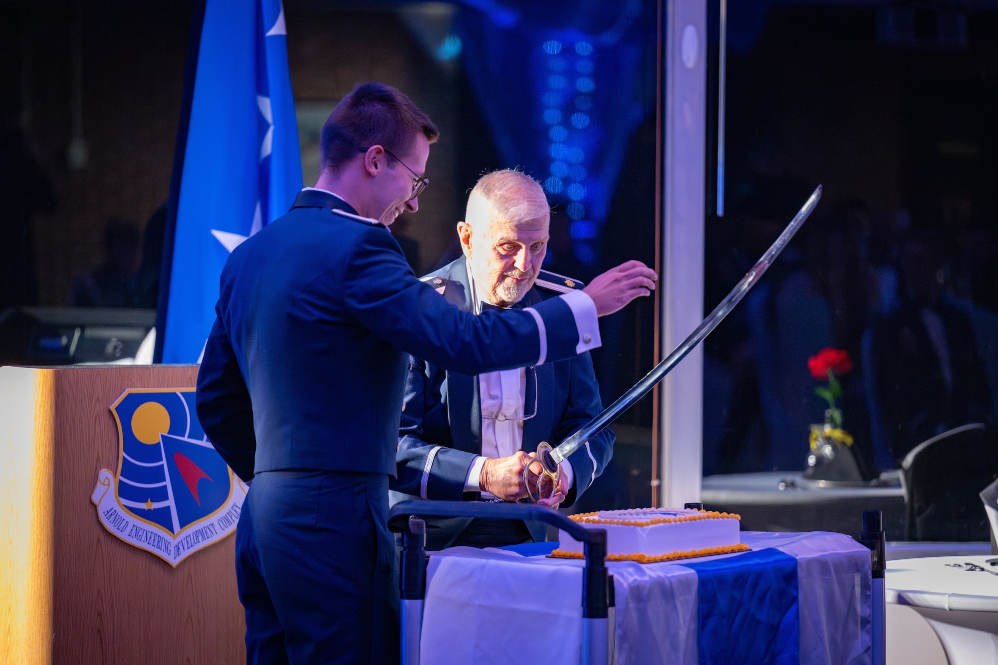 U.S. Air Force 2nd Lt. Zander Mulawka and Maj. (Ret.) Bill Boss perform the ceremonial cutting of the Air Force birthday cake during the 78th Anniversary Air Force Ball at Arnold Lakeside Complex, Arnold Air Force Base, Tenn., Sept. 13, 2025. It is tradition for the youngest Airman and the oldest Airman present to cut the cake together. The ball, hosted by the Arnold AFB Company Grade Officers’ Council, is an annual event held around the birthday of the U.S. Air Force to commemorate Airmen, celebrate service and reflect on the proud heritage of the U.S. Air Force. (Air Force photo by Keith Thornburgh) Disclaimer: The CGOC is a private organization which is not part of the Department of War or any of its components and has no governmental status.