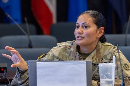 Master Sgt. Eva Miranda, 12th Finance Operations Center plans and operations advisor from Fort Knox, Kentucky, asks a question during a staff exercise in the Mark Sullivan Auditorium at the Maj. Gen. Emmett J. Bean Federal Center in Indianapolis Sept. 18, 2025. The four-day exercise brought together elements from the 45th FC’s headquarters and three geographically separated teams to assess the unit’s operational capacity and limitations while enhancing its future operational reach for large scale and multidomain operations. (U.S. Army photo by Mark R. W. Orders-Woempner)