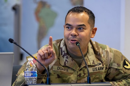 Maj. Danny Duarte, 45th Finance Center Team A officer in charge from Fort Knox, Kentucky, asks a question during a staff exercise in the Mark Sullivan Auditorium at the Maj. Gen. Emmett J. Bean Federal Center in Indianapolis Sept. 18, 2025. The four-day exercise brought together elements from the 45th FC’s headquarters and three geographically separated teams to assess the unit’s operational capacity and limitations while enhancing its future operational reach for large scale and multidomain operations. (U.S. Army photo by Mark R. W. Orders-Woempner)