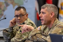 Col. Shaun D. McMurchie, 45th Finance Center director, makes remarks as Sgt. Maj. Rodani Tan, 45th FC senior enlisted advisor, listens during a staff exercise in the Mark Sullivan Auditorium at the Maj. Gen. Emmett J. Bean Federal Center in Indianapolis Sept. 18, 2025. The four-day exercise brought together elements from the 45th FC’s headquarters and three geographically separated teams to assess the unit’s operational capacity and limitations while enhancing its future operational reach for large scale and multidomain operations. (U.S. Army photo by Mark R. W. Orders-Woempner)
