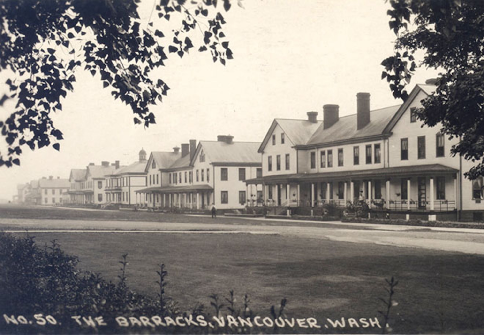 View of infantry barracks lining the parade ground at Vancouver Barracks.  In 1941, Vancouver Barracks supported the establishment of Portland Army Air Base (PAAB) with billeting, training and medical support for air base personnel awaiting completion of barracks at PAAB.  (Courtesy Oregon Historical Society Research Library, 57521)